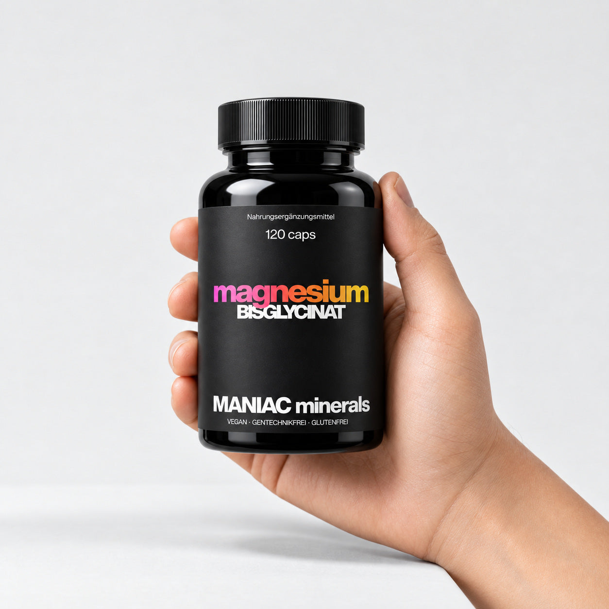 Magnesium Bisglycinat Dose in echter Größe in der Hand